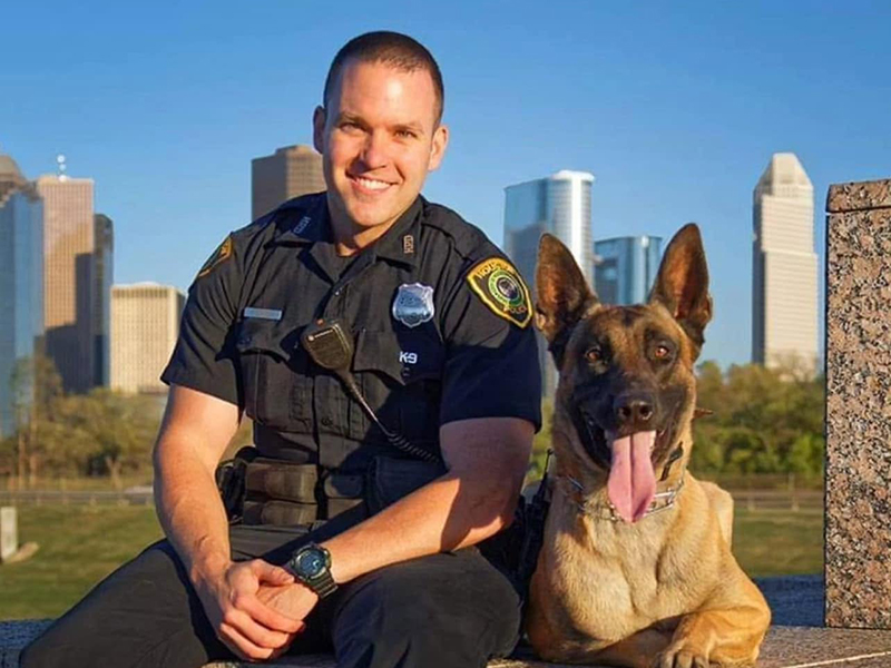 Police Officer sitting with a K-9 dog